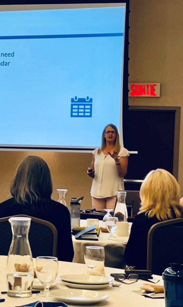Kirsten S. Albo speaking with a small group at an in-person training session
