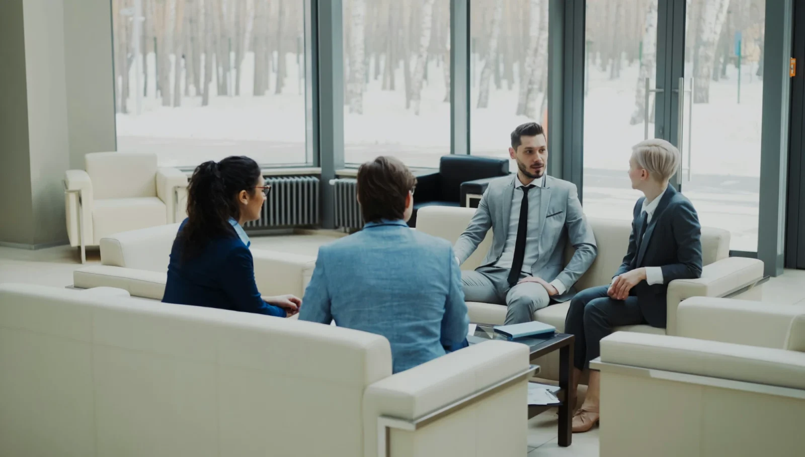 A diverse team in conversation in a modern office lounge